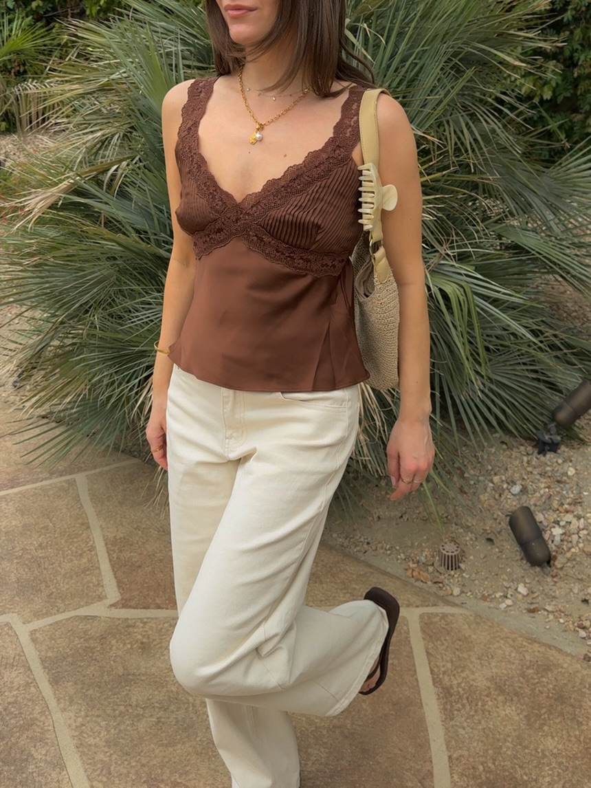 Brown ribbed camisole with lace trim along V-neckline and straps, solid brown fabric at hem, fitted bodice with slight peplum detail