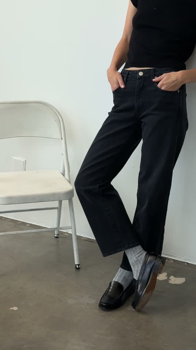 black wide-leg straight fit denim jeans with mid-rise waist, gold button closure, front pockets, and clean hem
