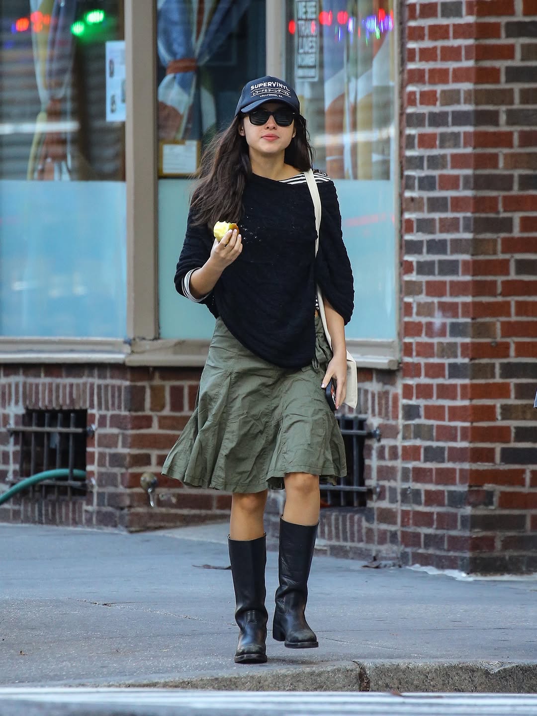 Olive green midi-length skirt with a gathered, pleated design and visible side pockets.
