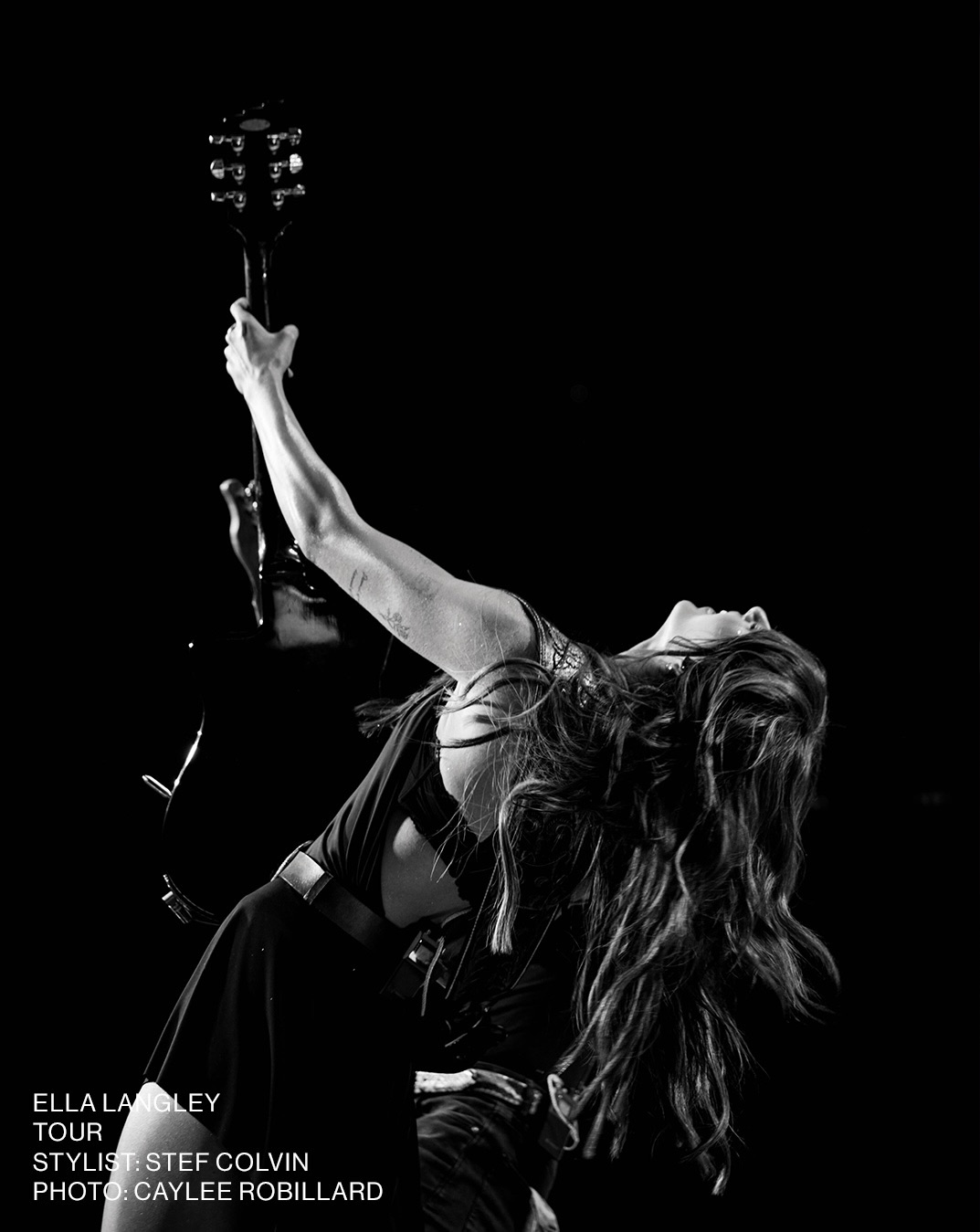 Black and white side profile of the performer wearing the dark halter dress.