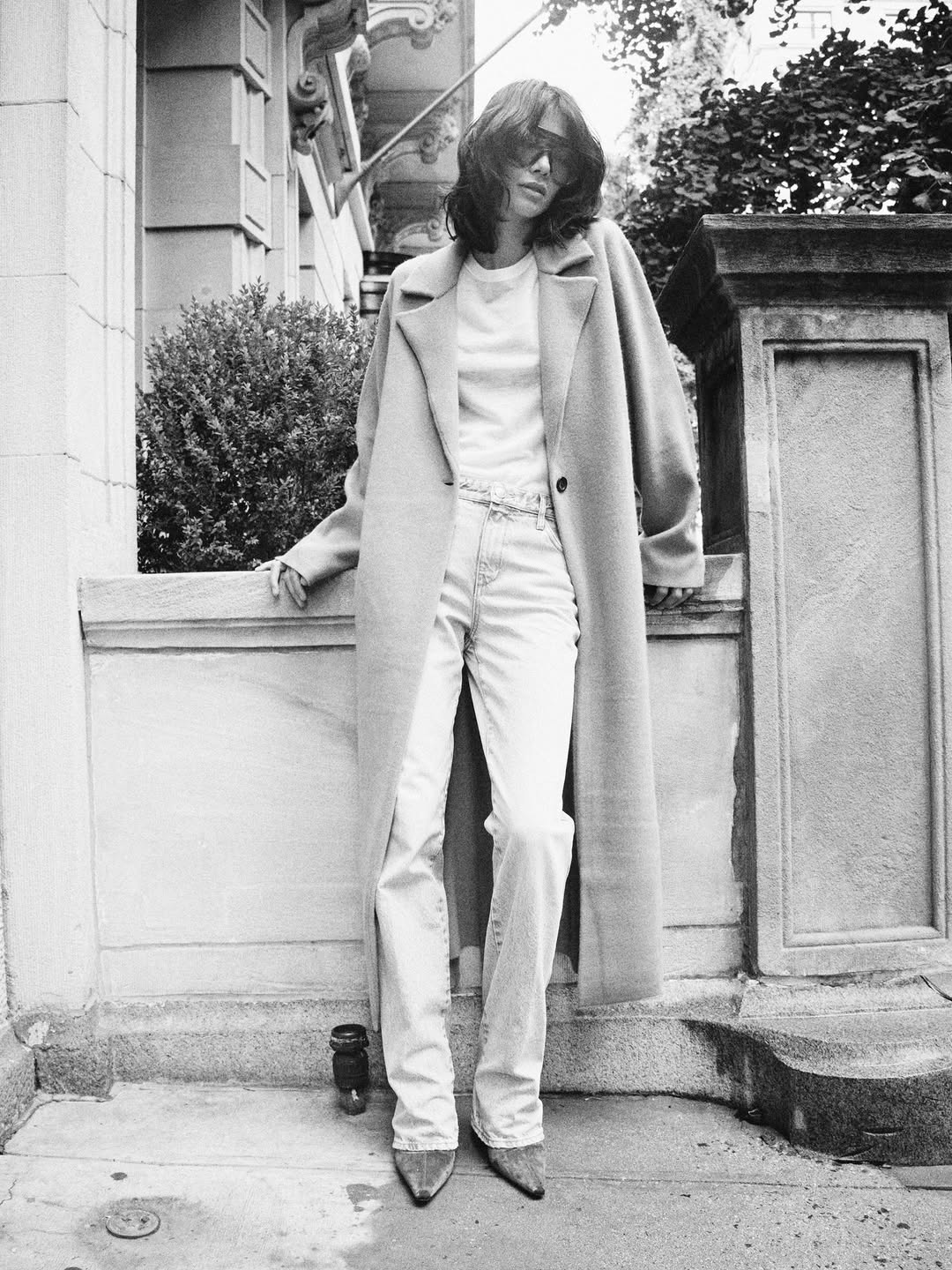 A long, oversized single-breasted coat with wide lapels and dropped shoulders. It appears to be made of a soft material like cashmere or wool blend.